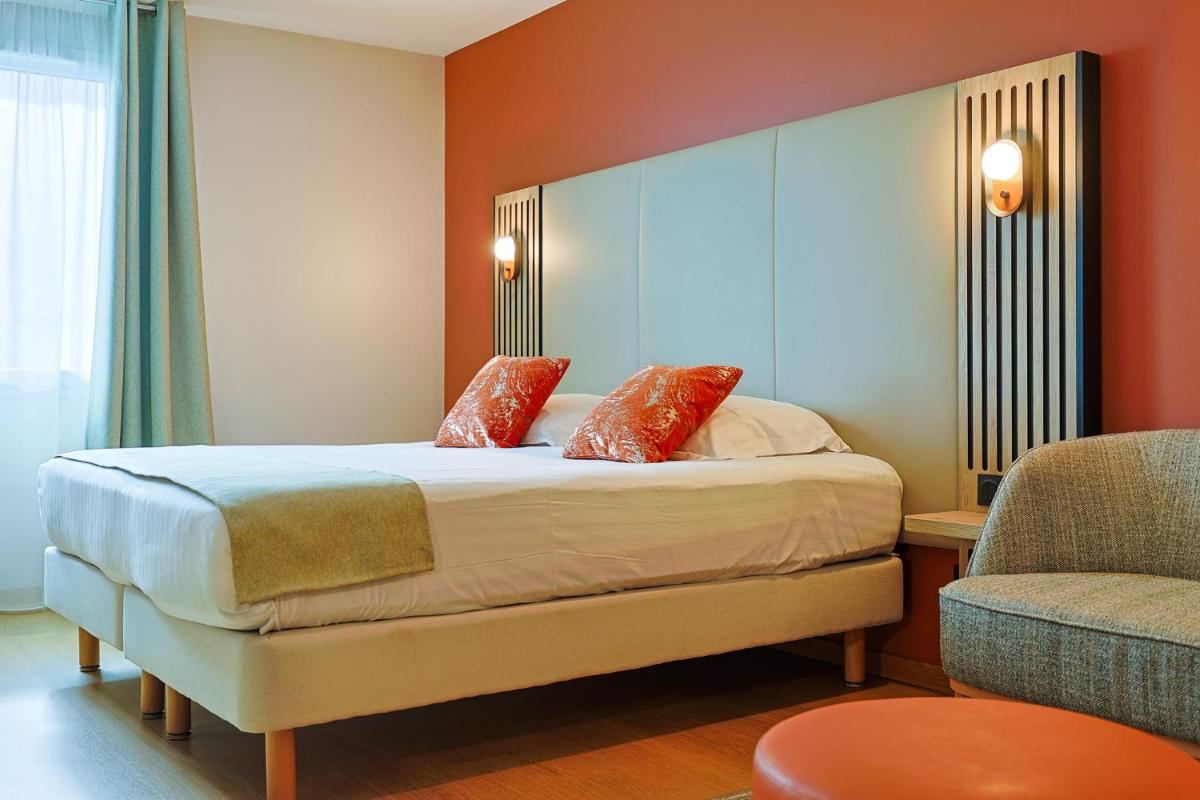 Un ou plusieurs lits dans un hébergement de l'établissement Seven Urban Suites Nantes Centre