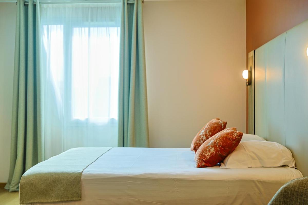 Un ou plusieurs lits dans un hébergement de l'établissement Seven Urban Suites Nantes Centre