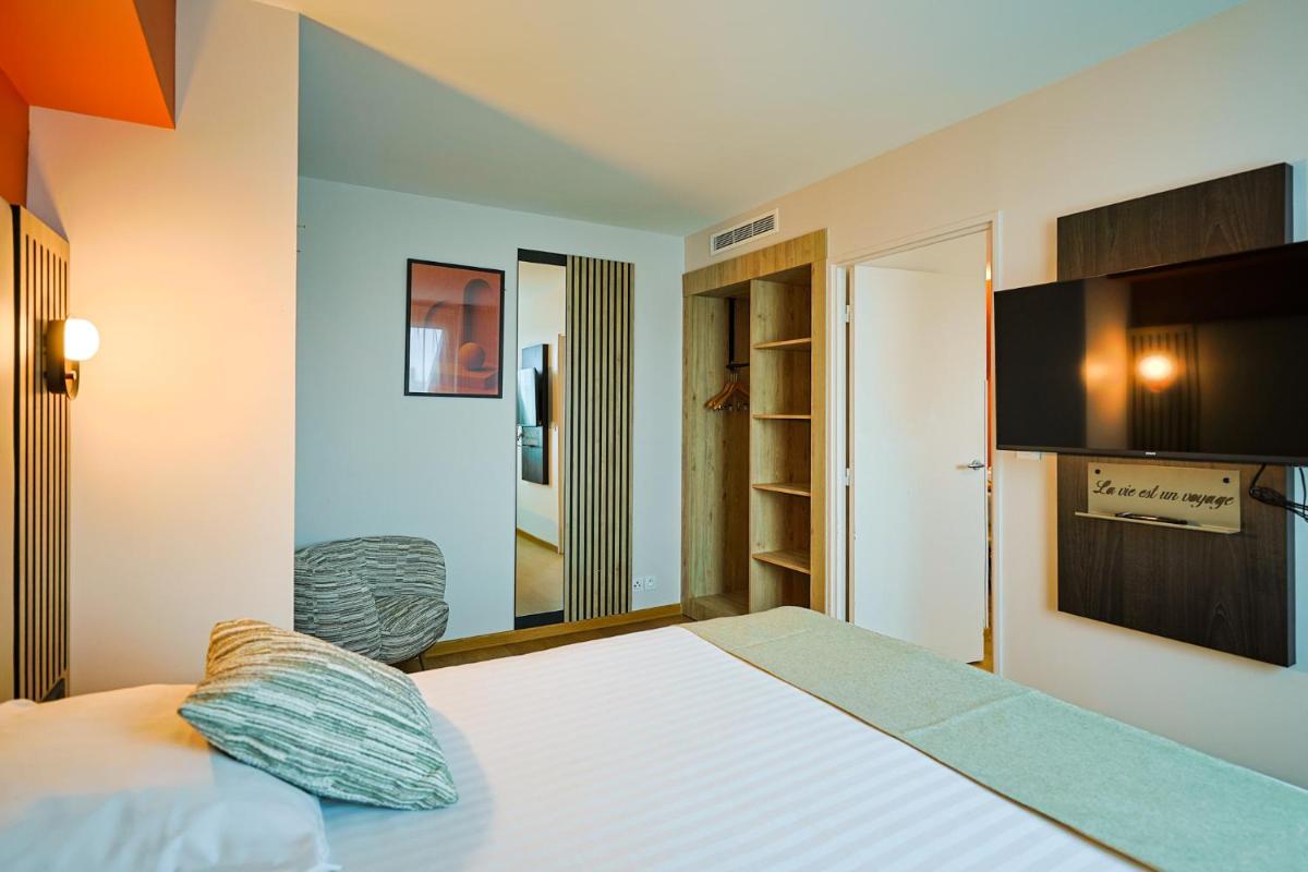 Télévision ou salle de divertissement dans l'établissement Seven Urban Suites Nantes Centre