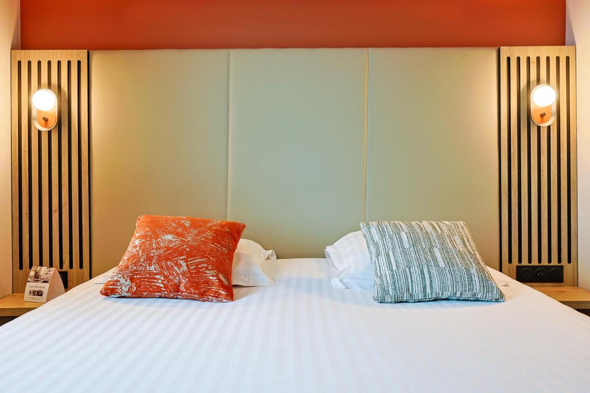 Un ou plusieurs lits dans un hébergement de l'établissement Seven Urban Suites Nantes Centre