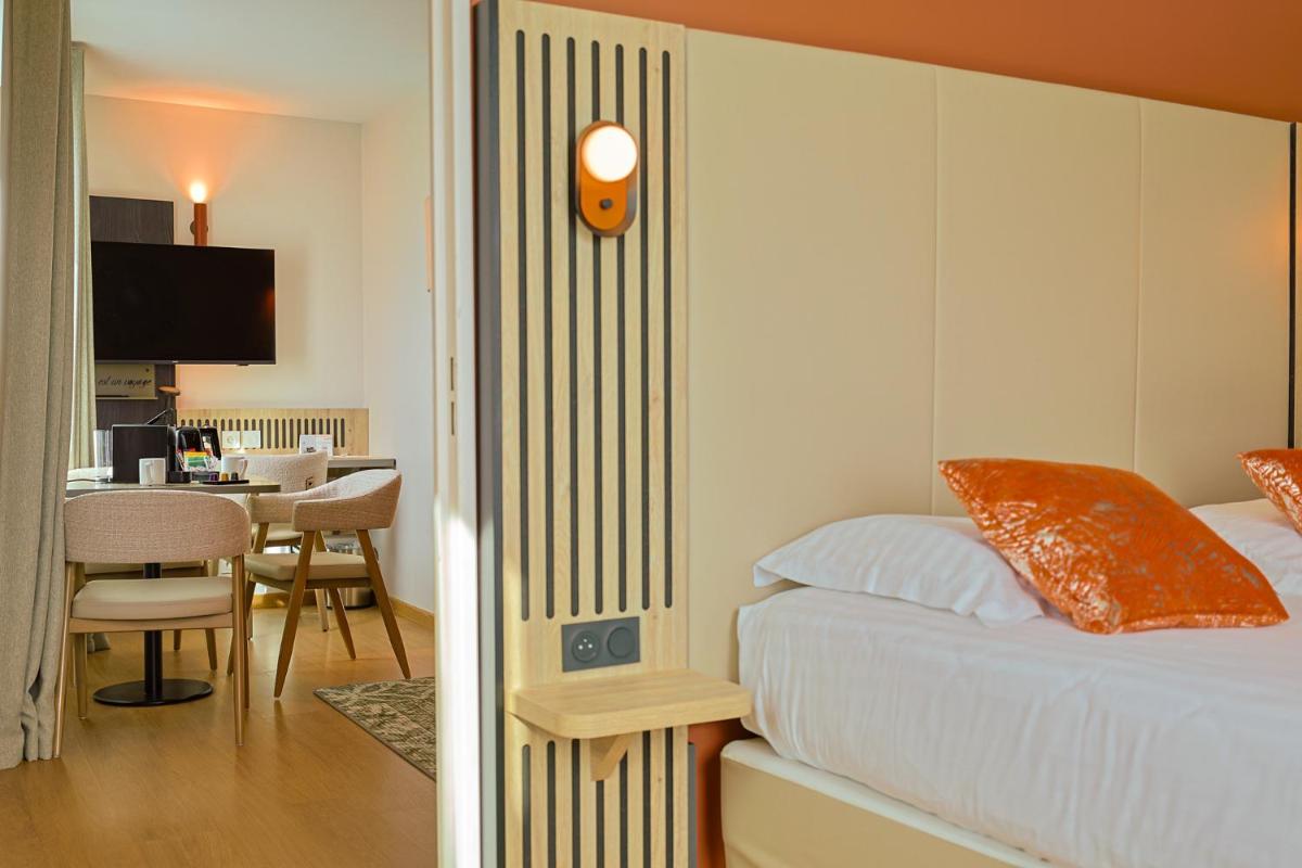 Un ou plusieurs lits dans un hébergement de l'établissement Seven Urban Suites Nantes Centre