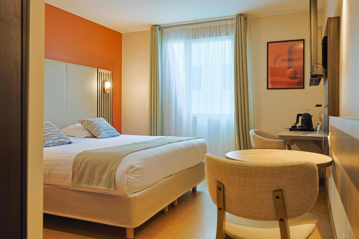 Un ou plusieurs lits dans un hébergement de l'établissement Seven Urban Suites Nantes Centre