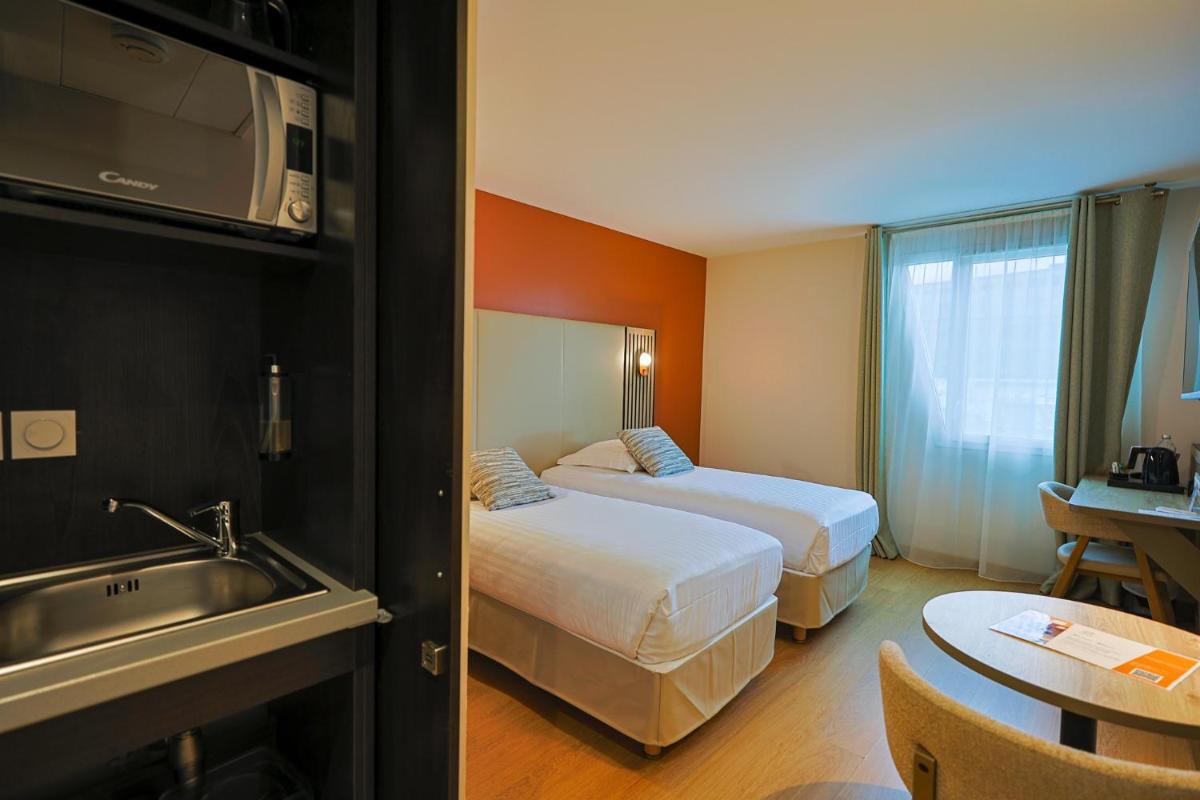 Un ou plusieurs lits dans un hébergement de l'établissement Seven Urban Suites Nantes Centre