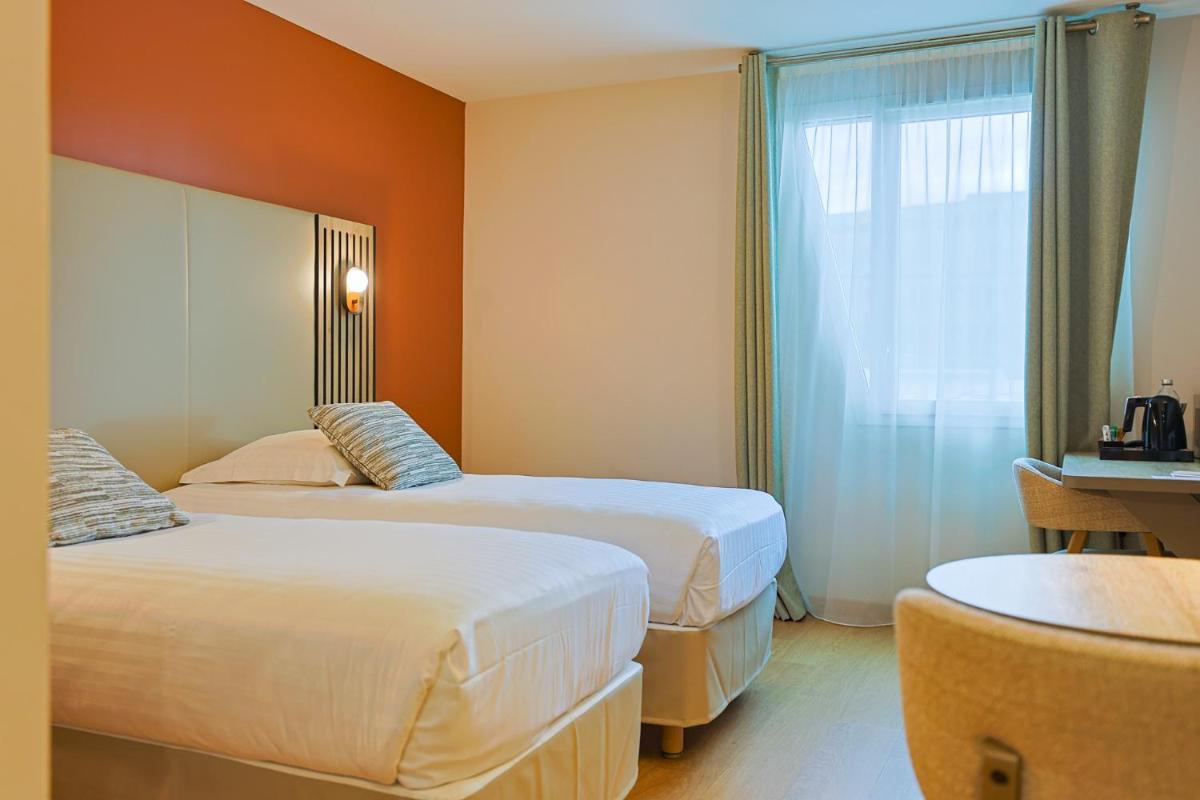 Un ou plusieurs lits dans un hébergement de l'établissement Seven Urban Suites Nantes Centre