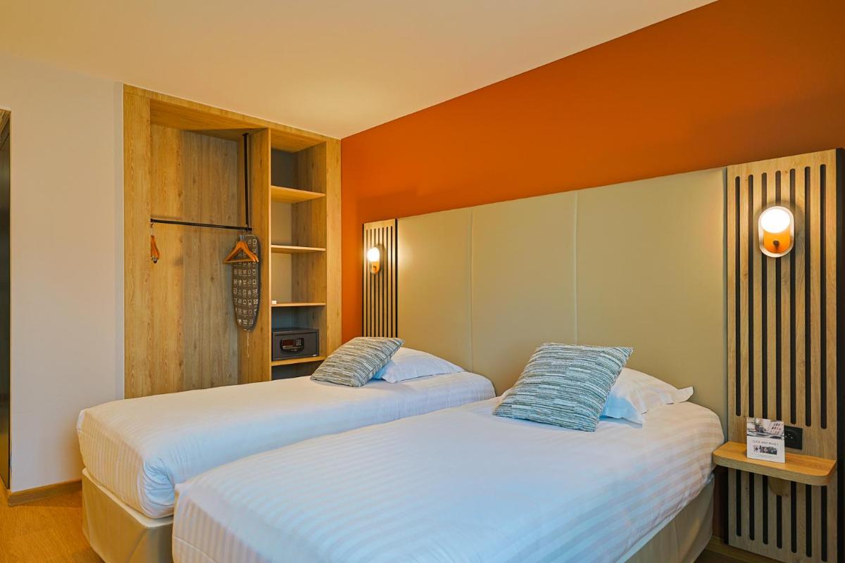 Un ou plusieurs lits dans un hébergement de l'établissement Seven Urban Suites Nantes Centre
