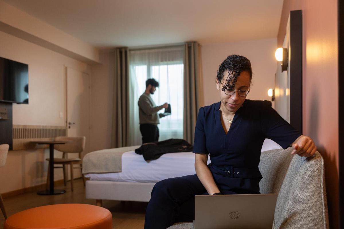 Un ou plusieurs lits dans un hébergement de l'établissement Seven Urban Suites Nantes Centre