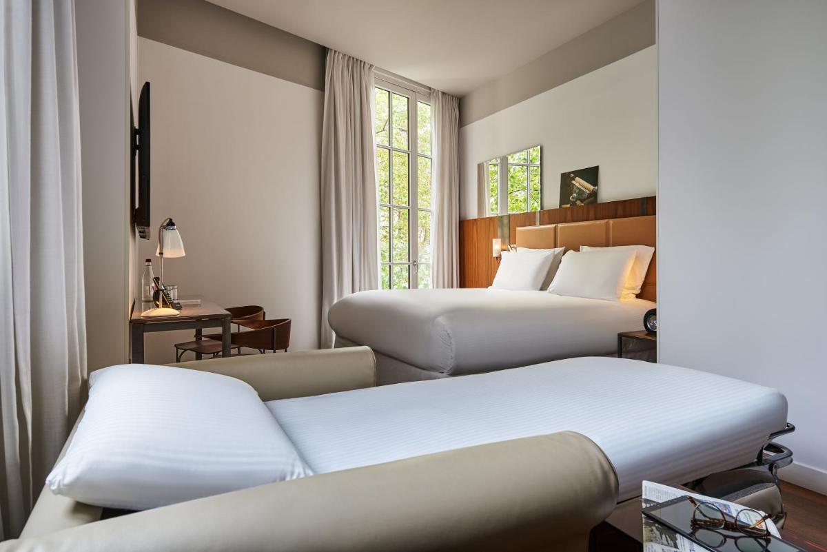 Un ou plusieurs lits dans un hébergement de l'établissement Boutet Bastille Hotel Paris - MGallery Collection