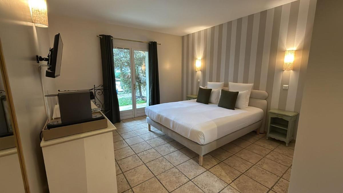 Un ou plusieurs lits dans un hébergement de l'établissement CÉRÈS - Boutique-Hôtel & Spa