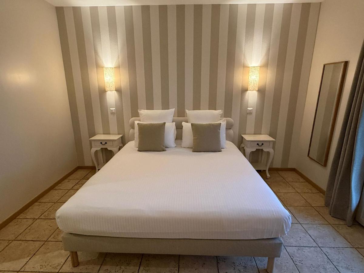 Un ou plusieurs lits dans un hébergement de l'établissement CÉRÈS - Boutique-Hôtel & Spa