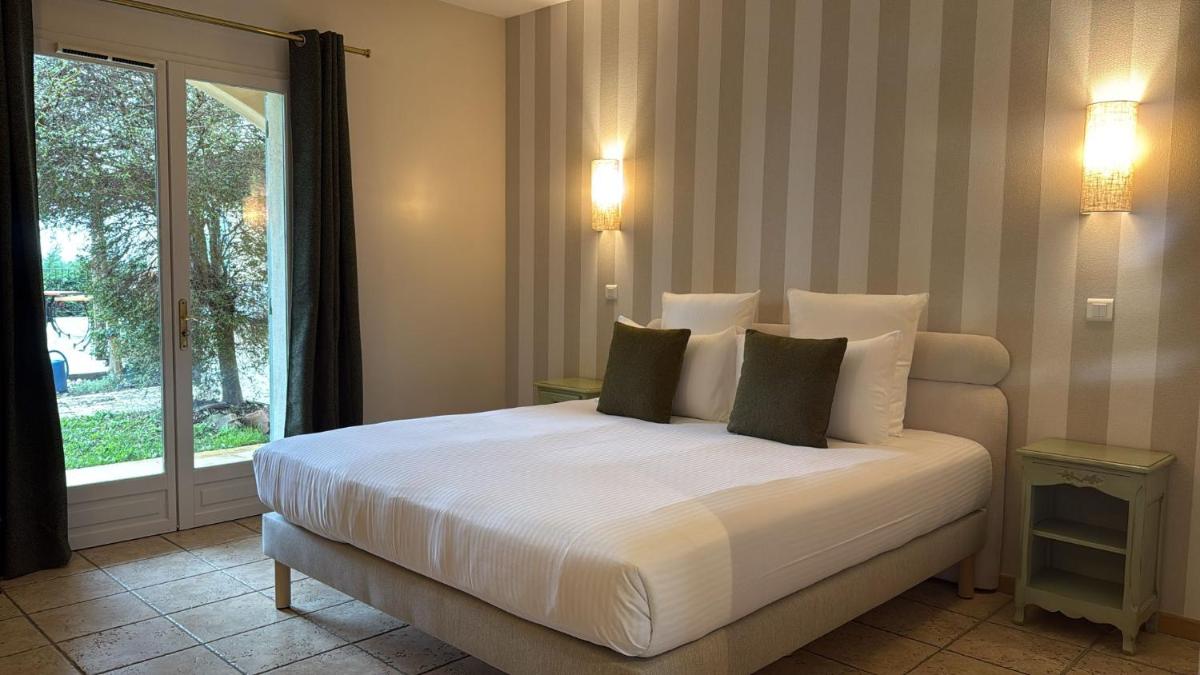 Un ou plusieurs lits dans un hébergement de l'établissement CÉRÈS - Boutique-Hôtel & Spa