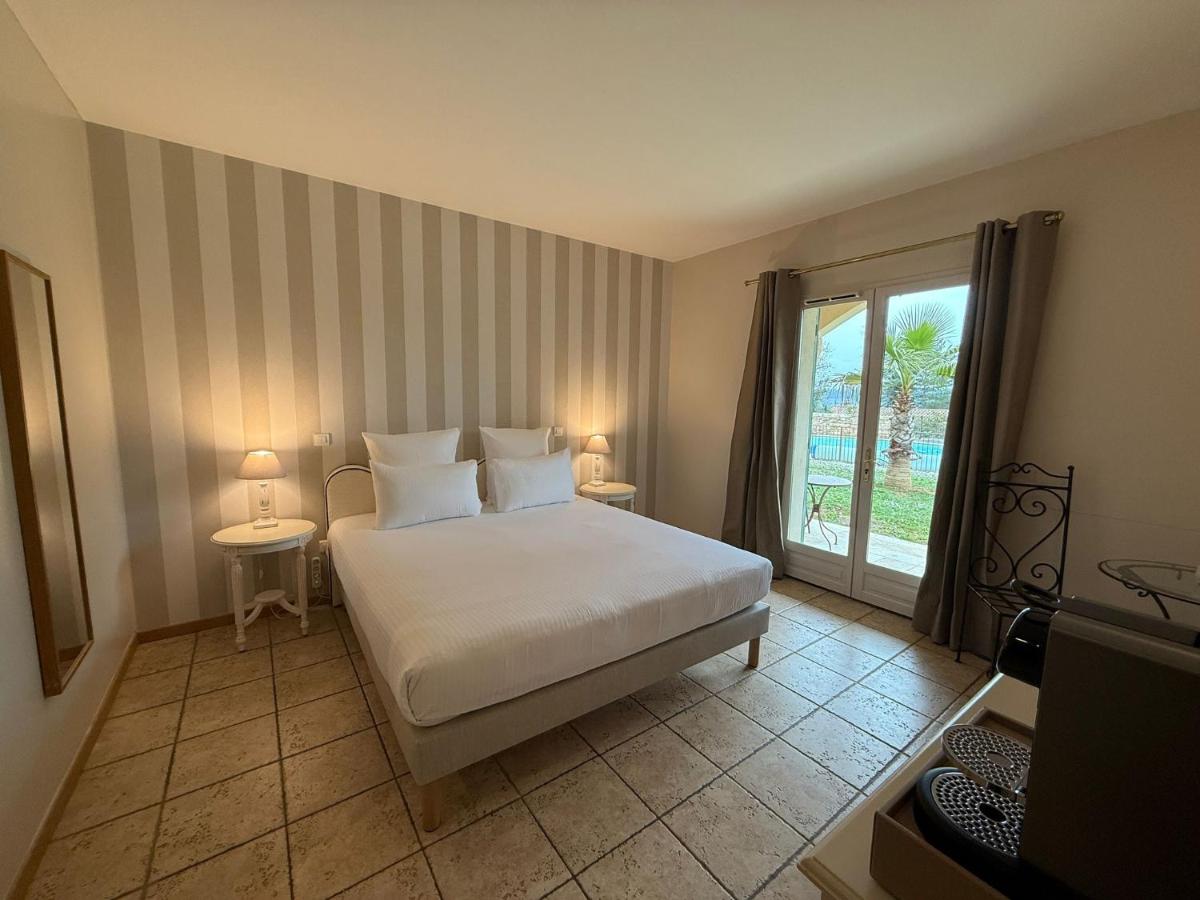 Un ou plusieurs lits dans un hébergement de l'établissement CÉRÈS - Boutique-Hôtel & Spa