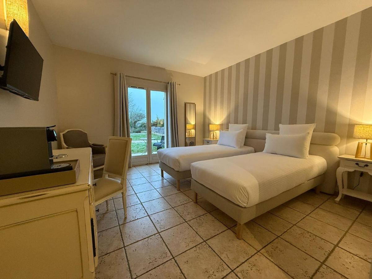 Un ou plusieurs lits dans un hébergement de l'établissement CÉRÈS - Boutique-Hôtel & Spa