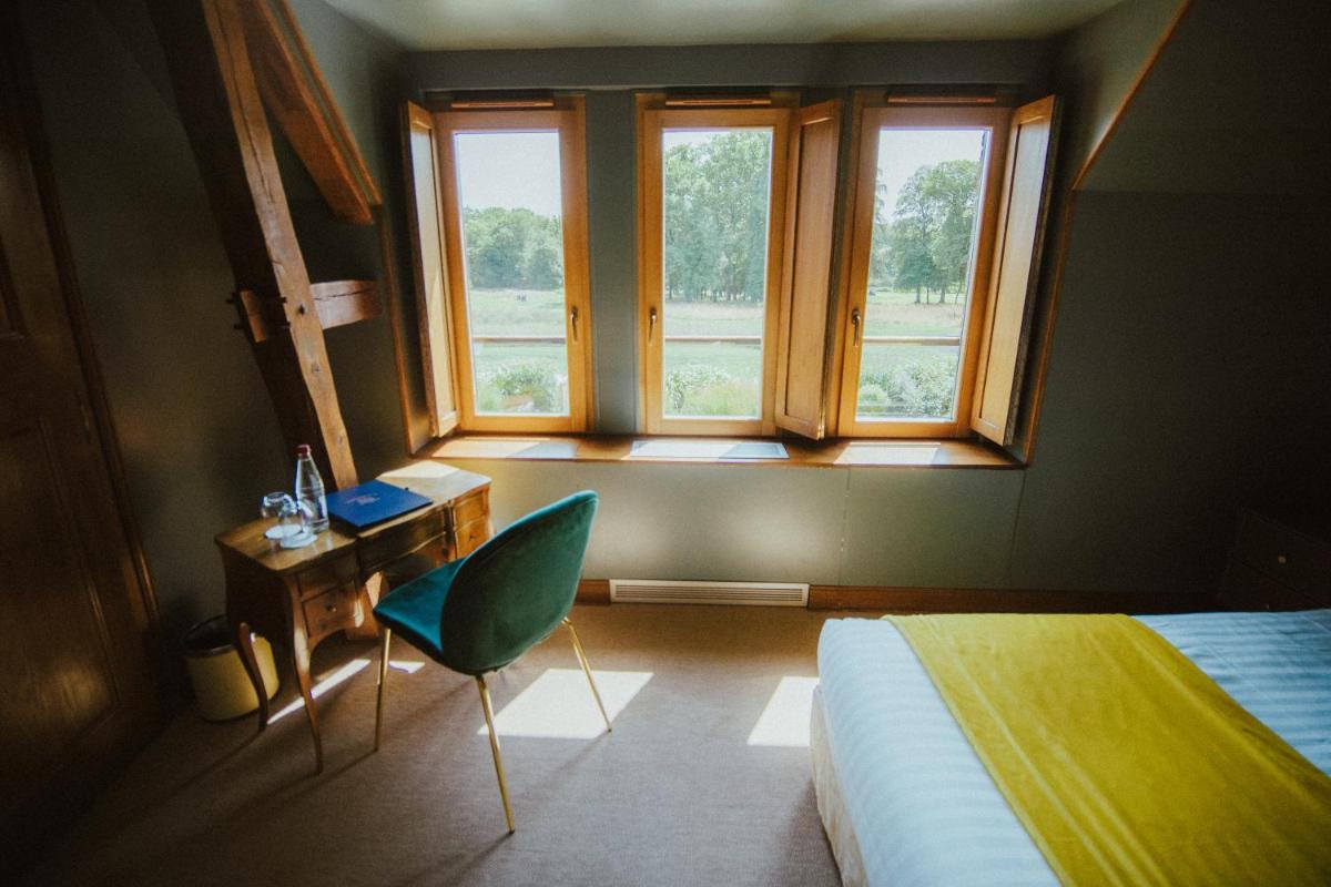 Un ou plusieurs lits dans un hébergement de l'établissement Domaine Du Roncemay - Hôtel, Restaurants, Spa & Golf