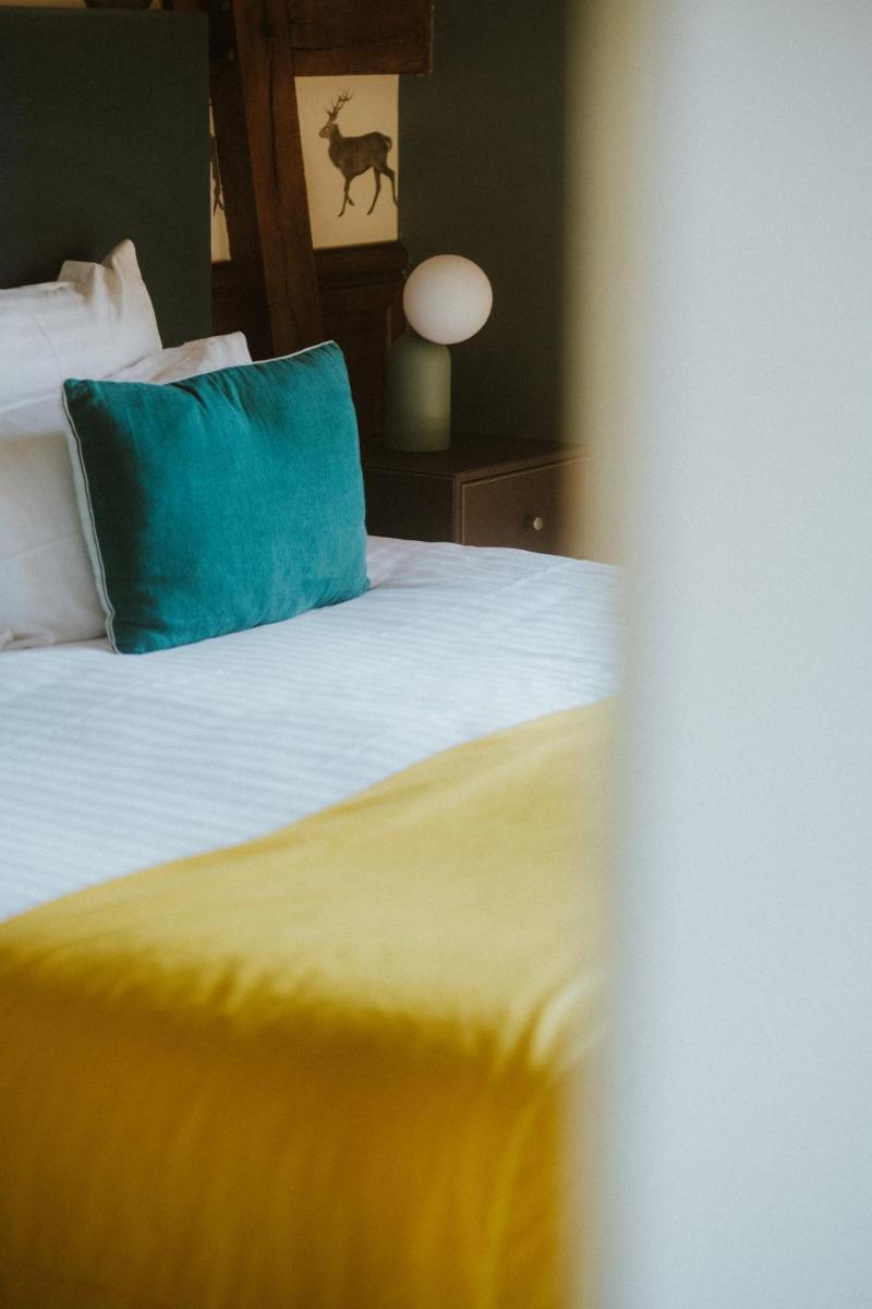 Un ou plusieurs lits dans un hébergement de l'établissement Domaine Du Roncemay - Hôtel, Restaurants, Spa & Golf