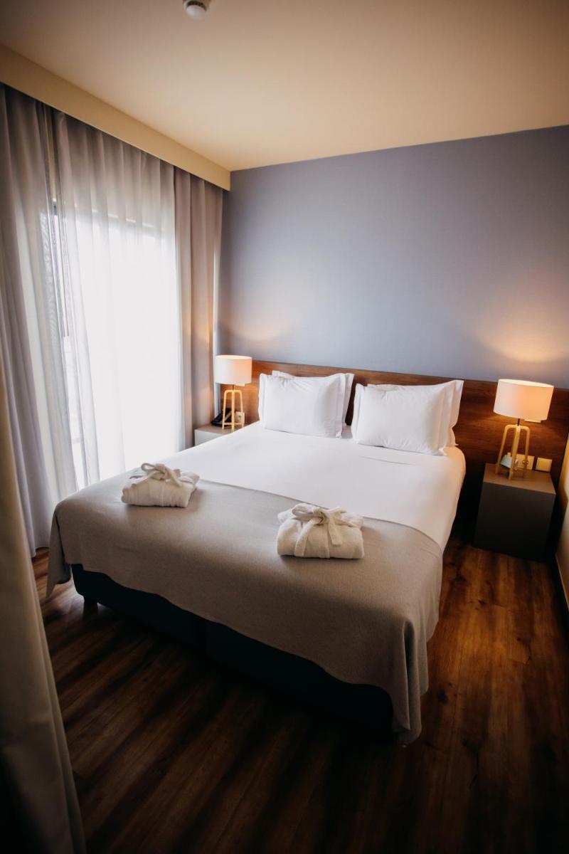 Uma cama ou camas num quarto em The Prime Energize Hotel & SPA - Algarve