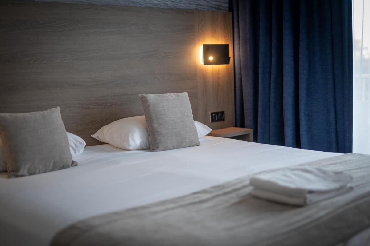Un ou plusieurs lits dans un hébergement de l'établissement Hotel Europa
