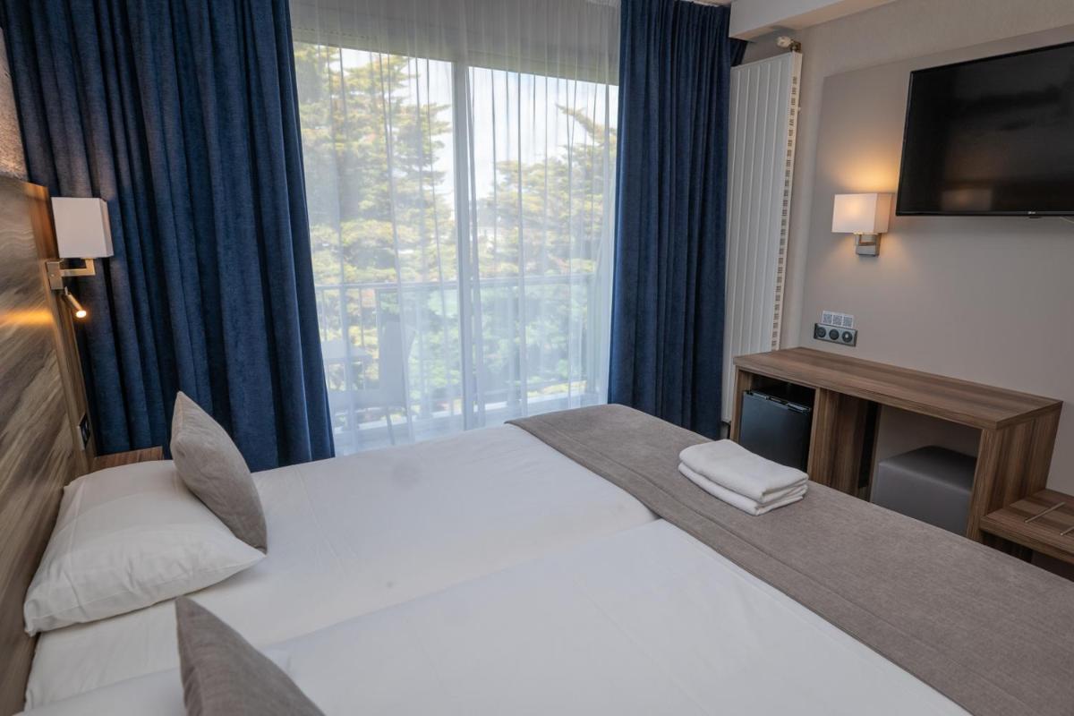 Un ou plusieurs lits dans un hébergement de l'établissement Hotel Europa