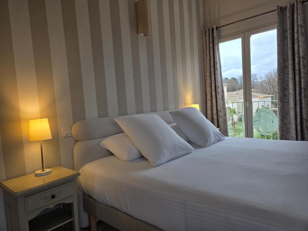 Un ou plusieurs lits dans un hébergement de l'établissement CÉRÈS - Boutique-Hôtel & Spa
