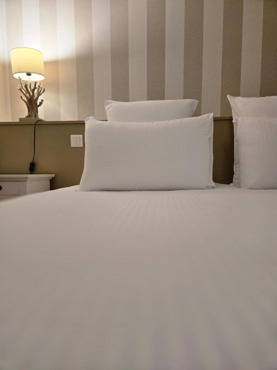 Un ou plusieurs lits dans un hébergement de l'établissement CÉRÈS - Boutique-Hôtel & Spa
