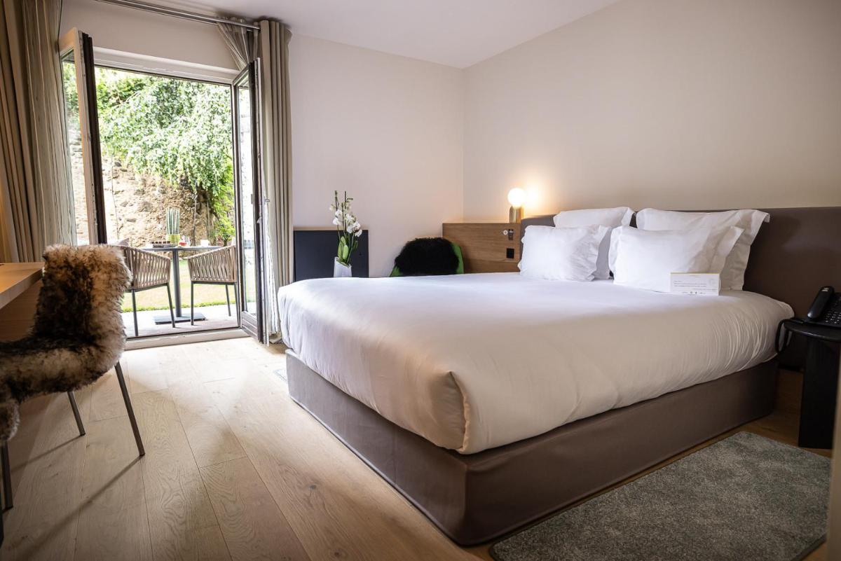 Un ou plusieurs lits dans un hébergement de l'établissement Relais et Châteaux Le Chambard