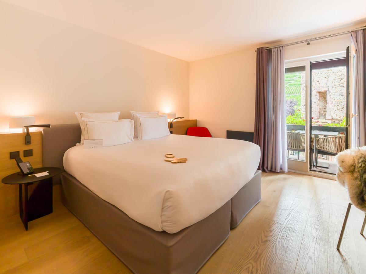Un ou plusieurs lits dans un hébergement de l'établissement Relais et Châteaux Le Chambard