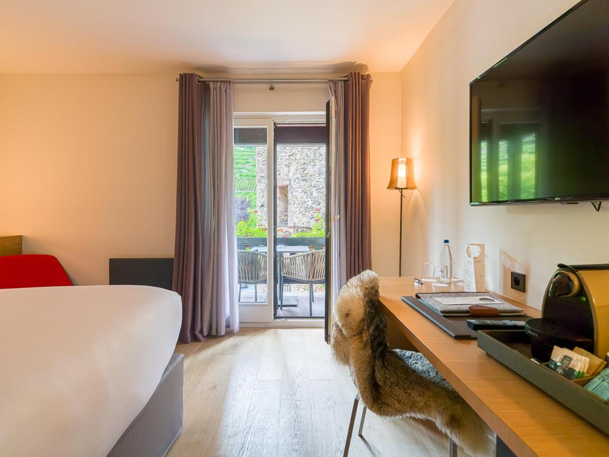 Un ou plusieurs lits dans un hébergement de l'établissement Relais et Châteaux Le Chambard
