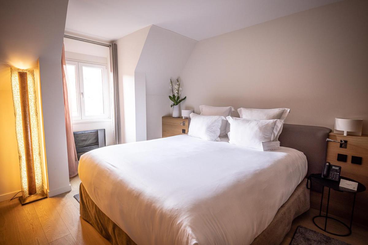 Un ou plusieurs lits dans un hébergement de l'établissement Relais et Châteaux Le Chambard