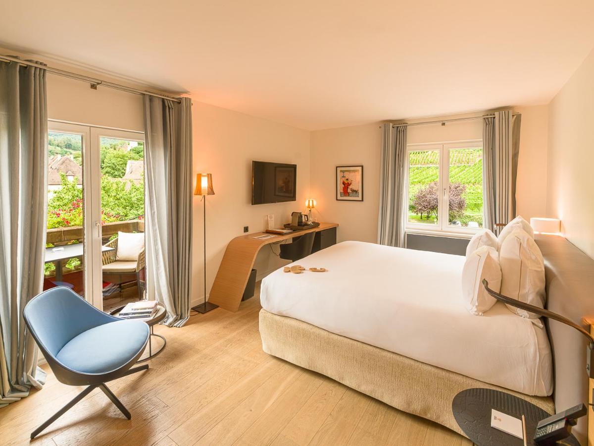 Un ou plusieurs lits dans un hébergement de l'établissement Relais et Châteaux Le Chambard
