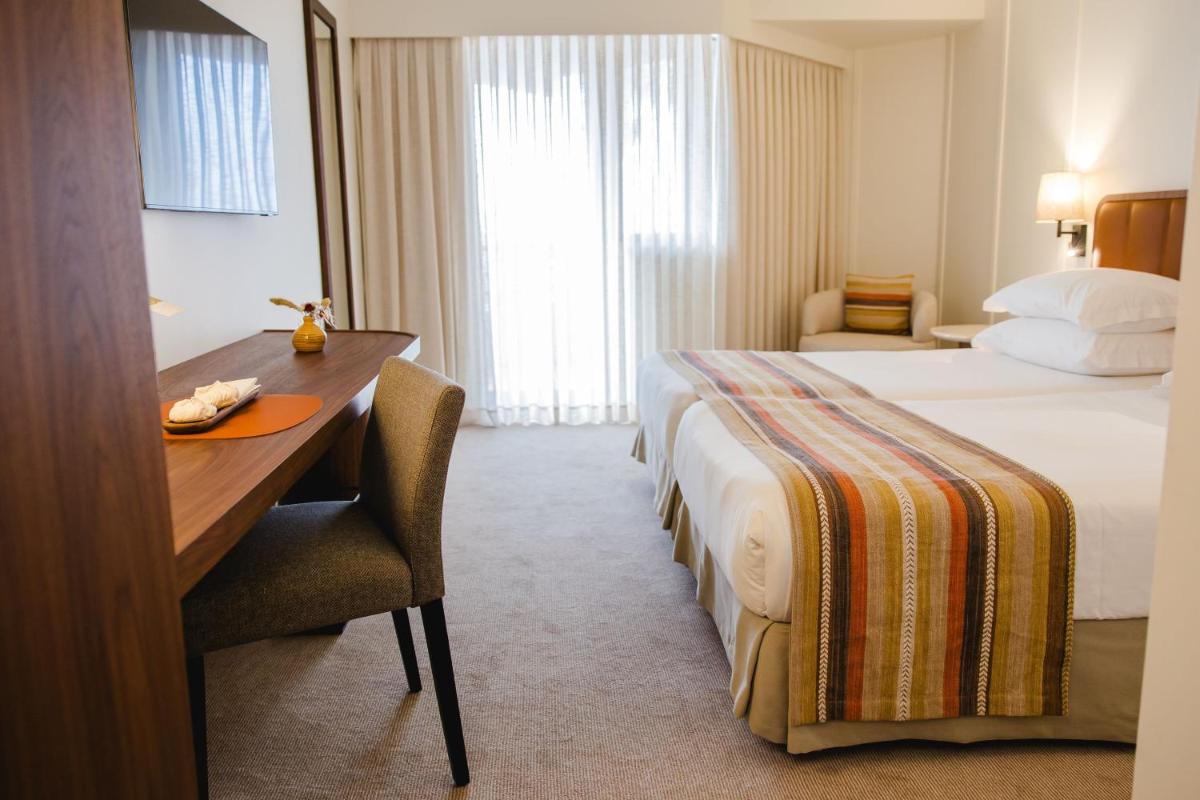 Uma cama ou camas num quarto em Evora Hotel