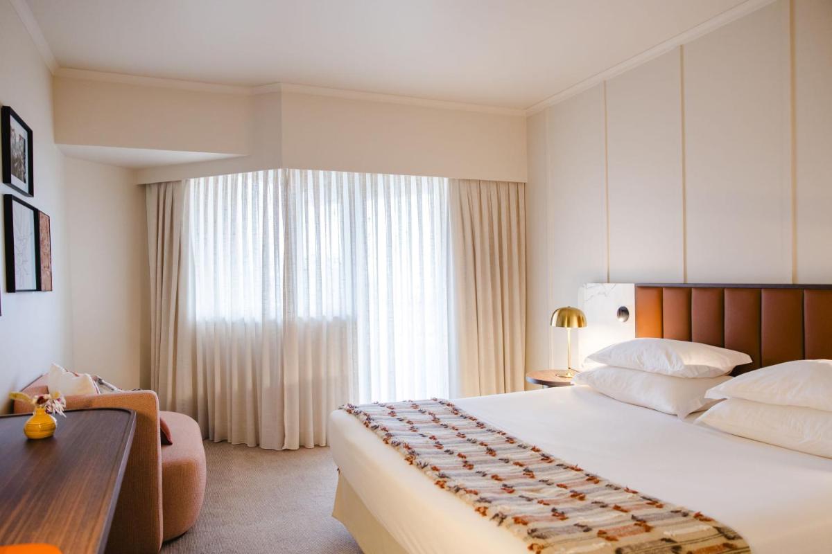 Uma cama ou camas num quarto em Evora Hotel