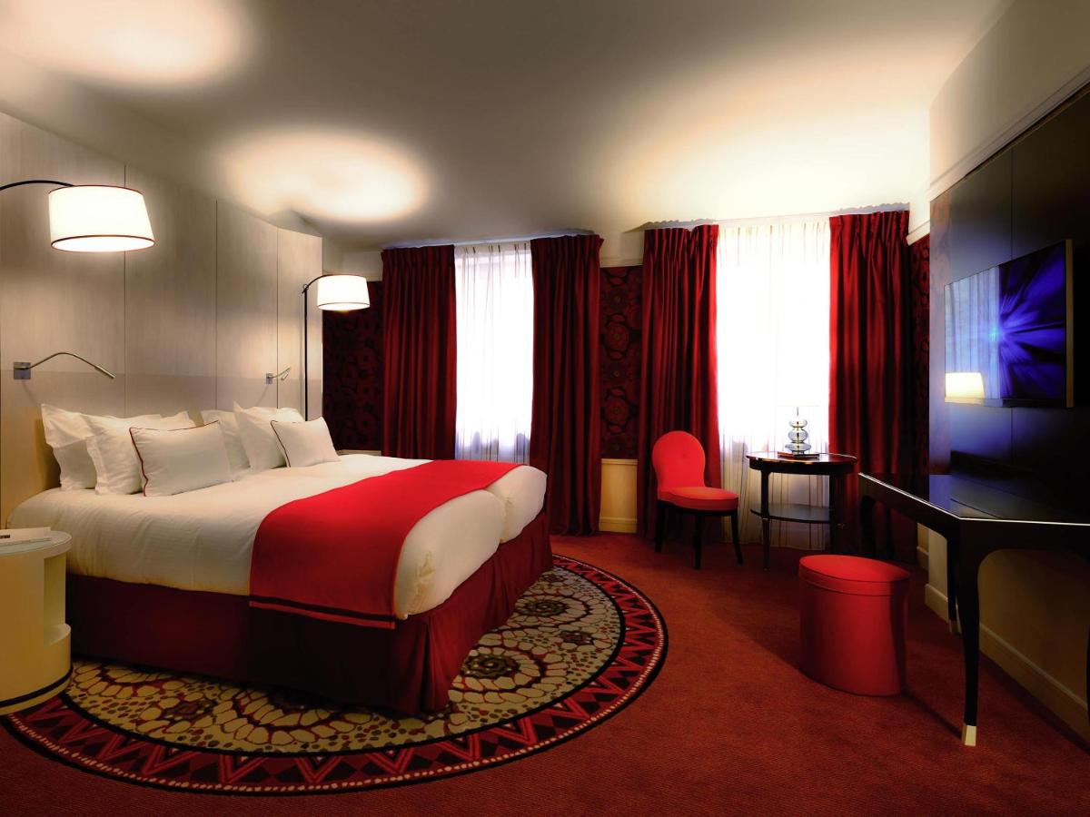 Un ou plusieurs lits dans un hébergement de l'établissement Carlton Hotel Lyon - MGallery Collection