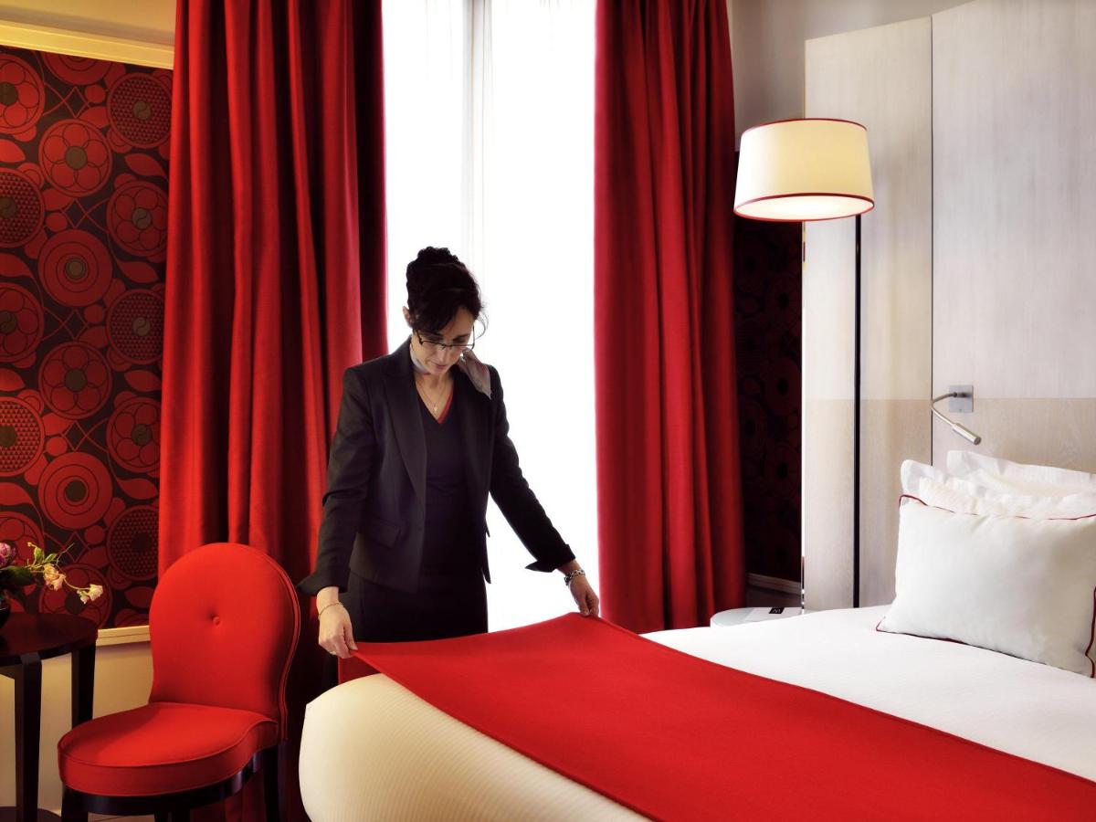 Un ou plusieurs lits dans un hébergement de l'établissement Carlton Hotel Lyon - MGallery Collection