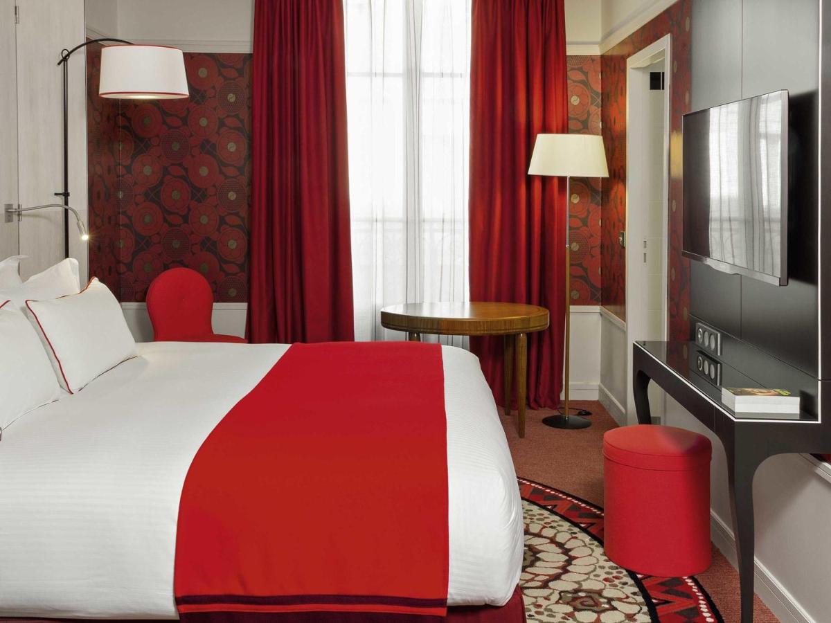 Un ou plusieurs lits dans un hébergement de l'établissement Carlton Hotel Lyon - MGallery Collection