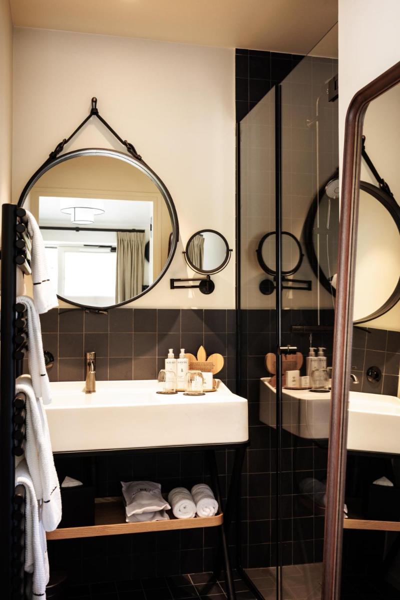une salle de bains avec un lavabo et un miroir dans l'établissement Domaine de Locguénolé & Spa - Relais & Chateaux, à Kervignac