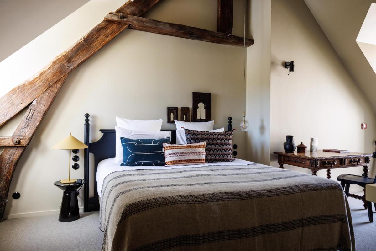 Un ou plusieurs lits dans un hébergement de l'établissement Domaine de Locguénolé & Spa - Relais & Chateaux