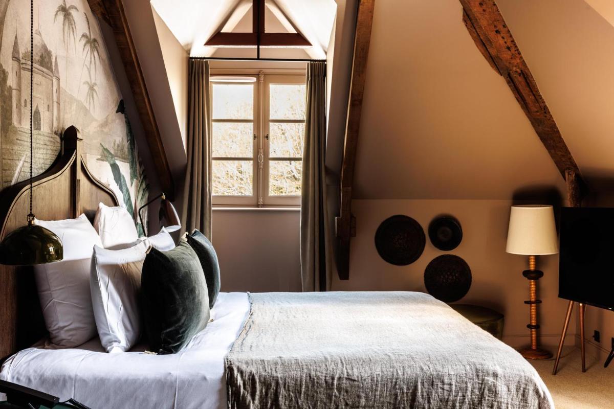 Un ou plusieurs lits dans un hébergement de l'établissement Domaine de Locguénolé & Spa - Relais & Chateaux