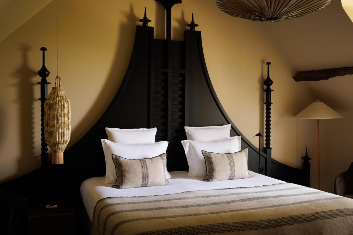 Un ou plusieurs lits dans un hébergement de l'établissement Domaine de Locguénolé & Spa - Relais & Chateaux