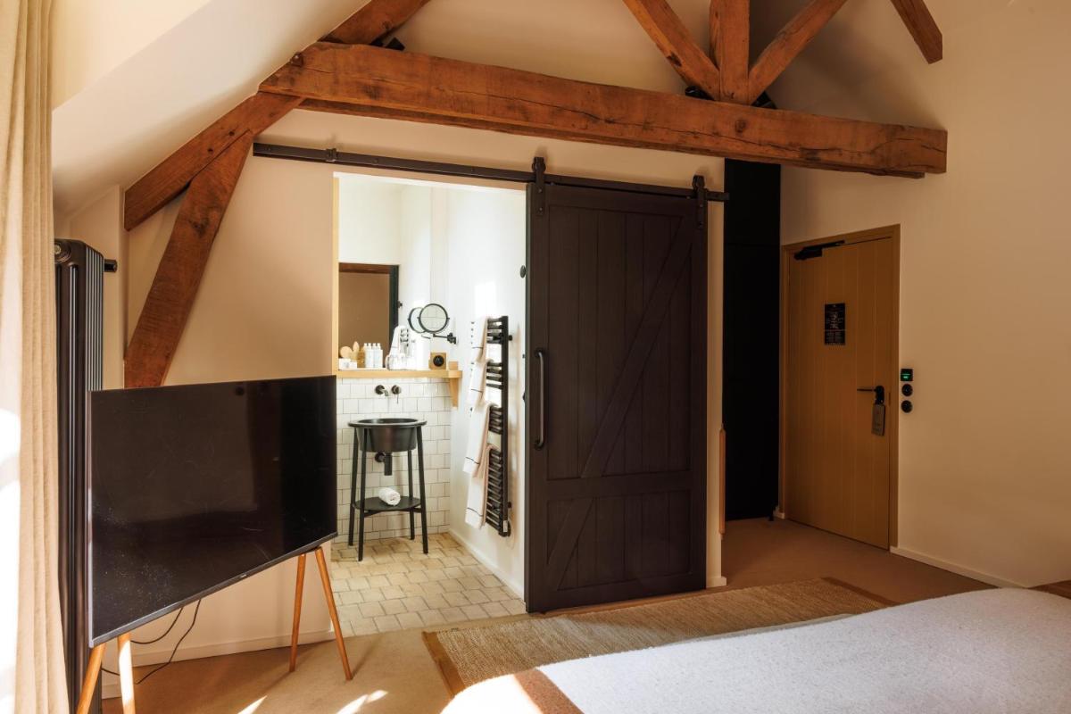 Un ou plusieurs lits dans un hébergement de l'établissement Domaine de Locguénolé & Spa - Relais & Chateaux