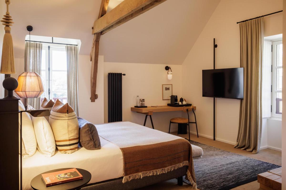 Un ou plusieurs lits dans un hébergement de l'établissement Domaine de Locguénolé & Spa - Relais & Chateaux