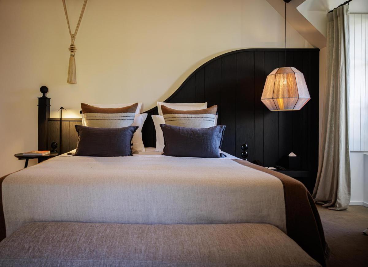 Un ou plusieurs lits dans un hébergement de l'établissement Domaine de Locguénolé & Spa - Relais & Chateaux