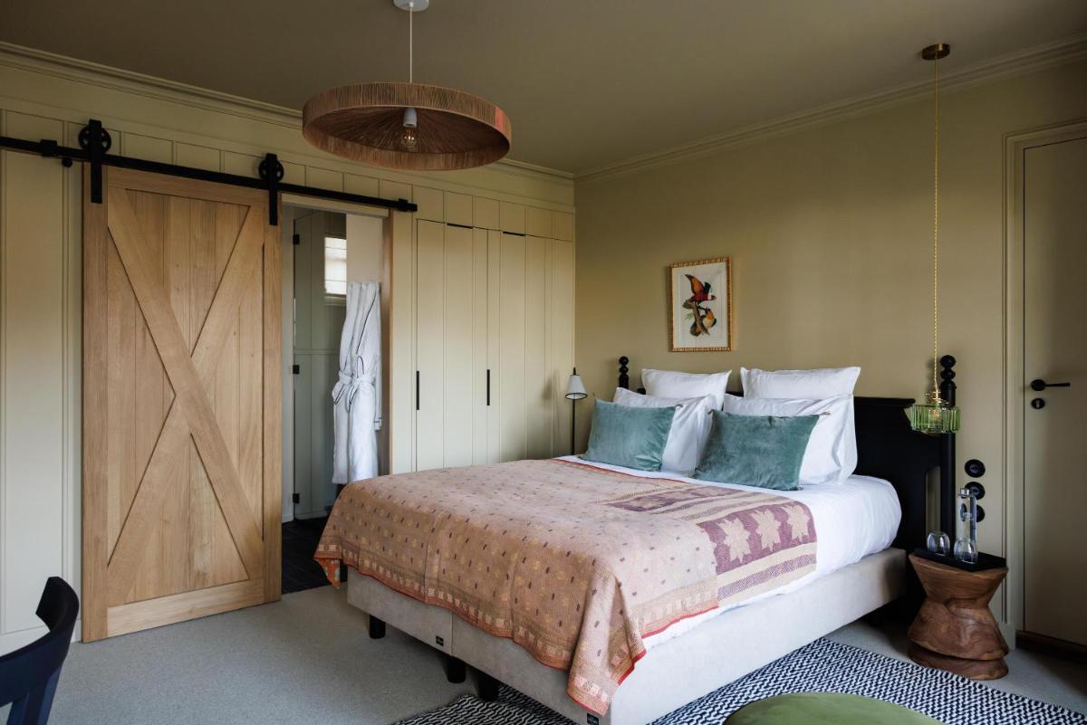 Un ou plusieurs lits dans un hébergement de l'établissement Domaine de Locguénolé & Spa - Relais & Chateaux