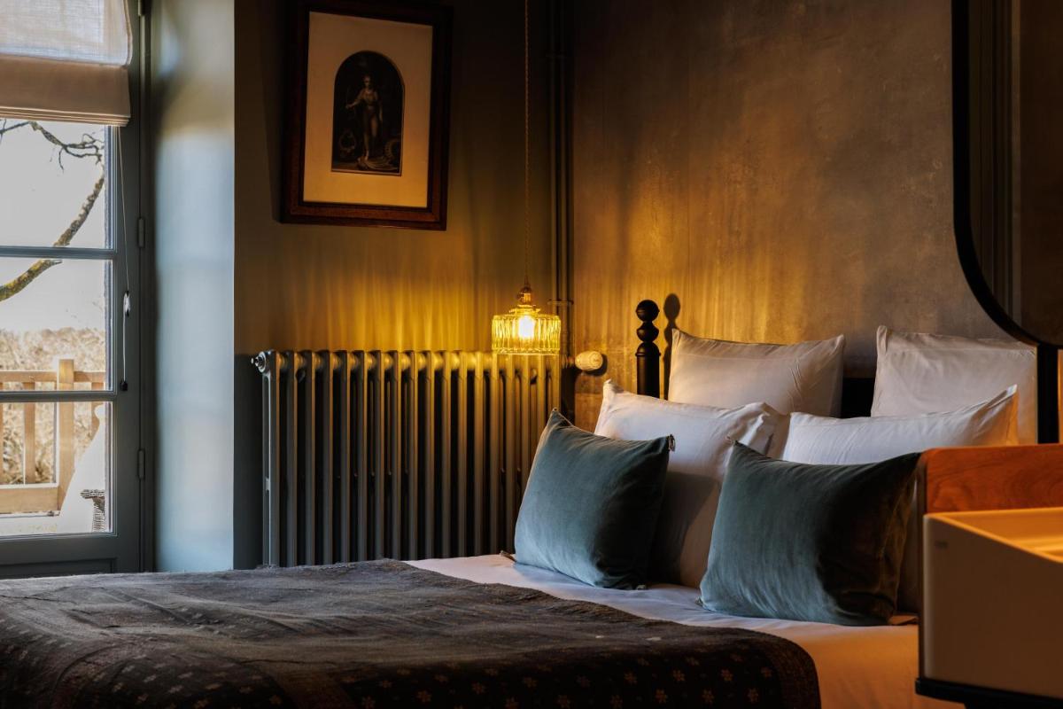 Un ou plusieurs lits dans un hébergement de l'établissement Domaine de Locguénolé & Spa - Relais & Chateaux