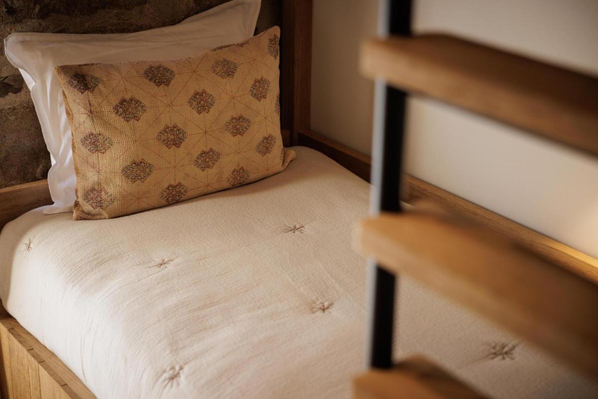 Un ou plusieurs lits dans un hébergement de l'établissement Domaine de Locguénolé & Spa - Relais & Chateaux