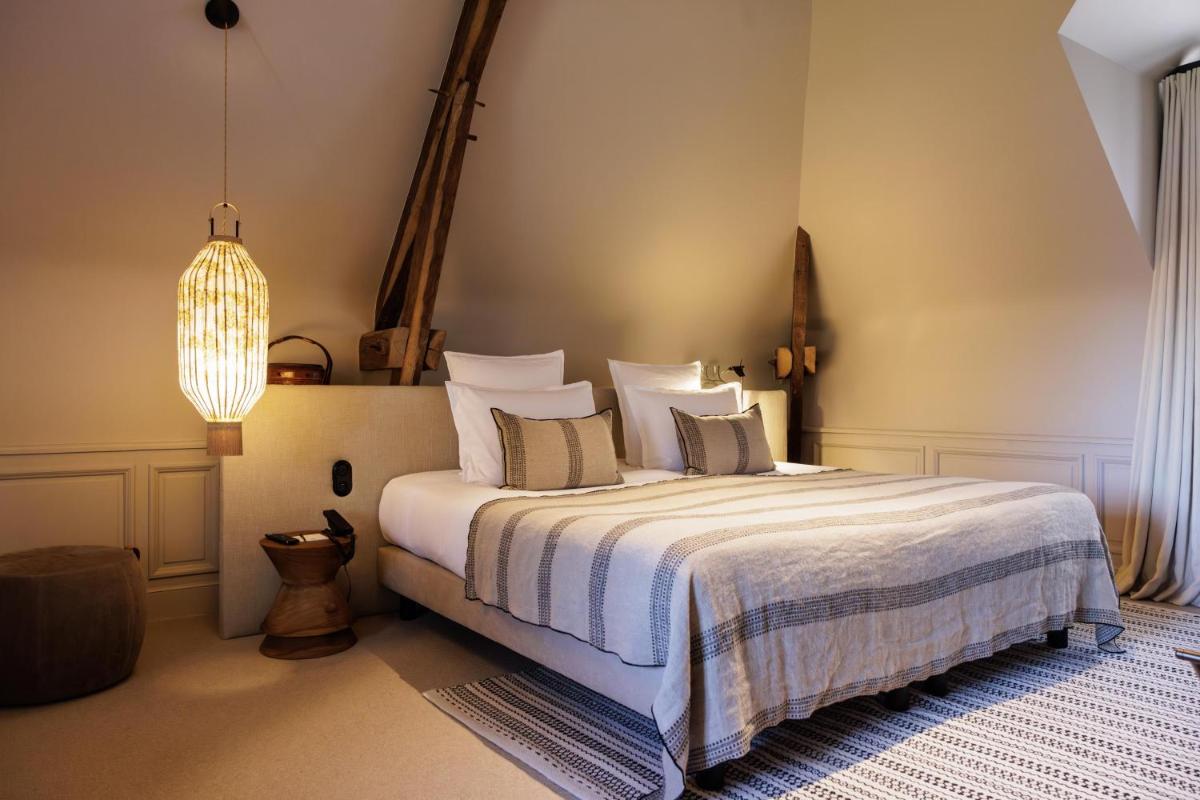 Un ou plusieurs lits dans un hébergement de l'établissement Domaine de Locguénolé & Spa - Relais & Chateaux