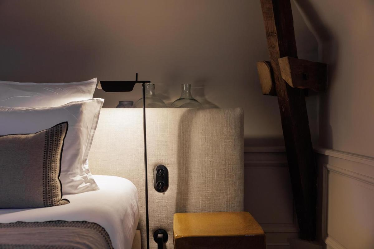 Un ou plusieurs lits dans un hébergement de l'établissement Domaine de Locguénolé & Spa - Relais & Chateaux