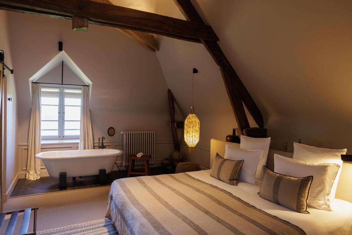 Un ou plusieurs lits dans un hébergement de l'établissement Domaine de Locguénolé & Spa - Relais & Chateaux