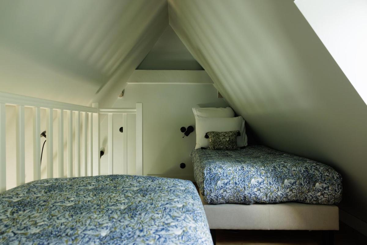 Un ou plusieurs lits dans un hébergement de l'établissement Domaine de Locguénolé & Spa - Relais & Chateaux