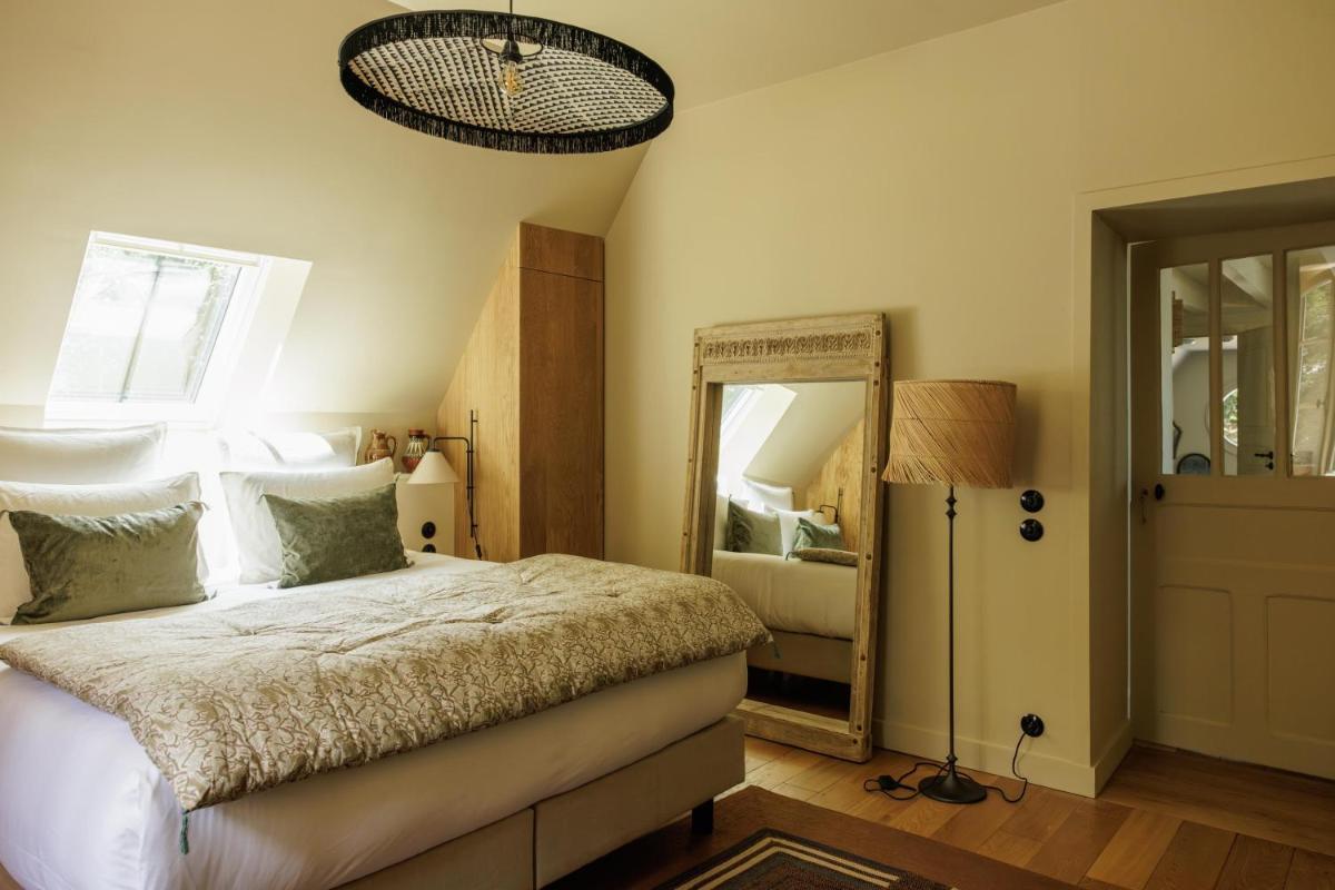 Un ou plusieurs lits dans un hébergement de l'établissement Domaine de Locguénolé & Spa - Relais & Chateaux
