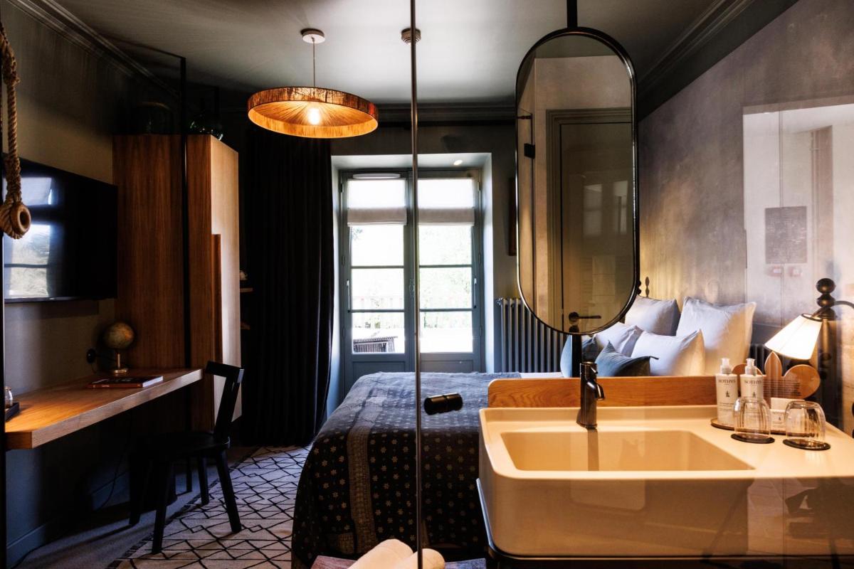 Un ou plusieurs lits dans un hébergement de l'établissement Domaine de Locguénolé & Spa - Relais & Chateaux