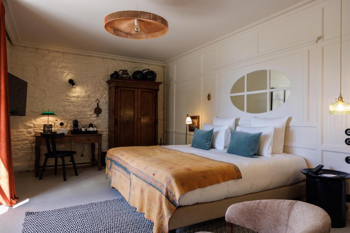 Un ou plusieurs lits dans un hébergement de l'établissement Domaine de Locguénolé & Spa - Relais & Chateaux